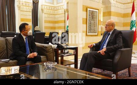 Prime Minister of Lebanon Najib Mikati and his wife May Mikati sign a