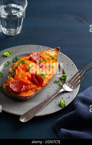 twice baked sweet potato with cheese and chorizo sausage Stock Photo