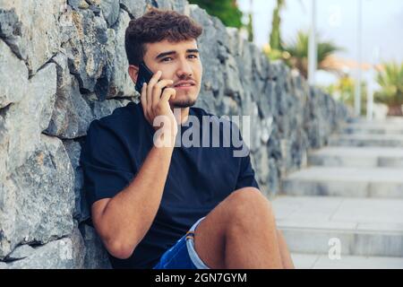 Closeup of the young man talking on the phone. Stock Photo