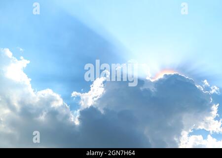 Fantastic Sunbeam Shining Through the Fluffy Cumulus Clouds Stock Photo