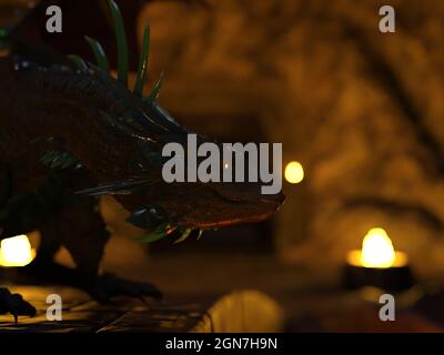 3d illustration of a dragon on a stone bridge looking forward into the distance with head down in a cavern. Stock Photo
