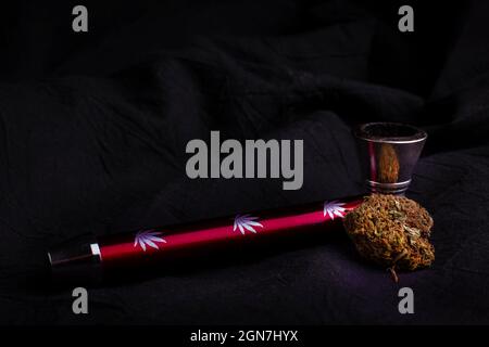 Green Marijuana Bud  On A black background With Smoking Pipe. Stock Photo