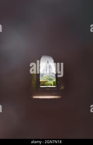 View of St. Peter's Dome through the keyhole at Knights of Malta square on the Aventine Hill in Rome Stock Photo