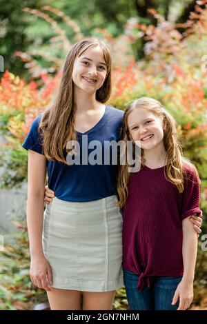 Two sisters embracing outside in the spring Stock Photo