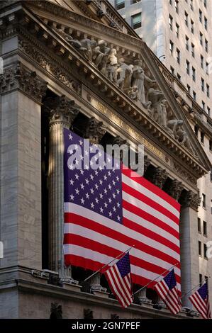 large American flag flying in front of the New York Stock exchange Manhattan NYC Stock Photo