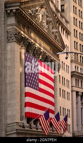 large American flag flying in front of the New York Stock exchange Manhattan NYC Stock Photo