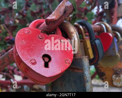An old red heart shaped rusty wedding lock, concept of  eternal love, everlasting love, undying love Stock Photo