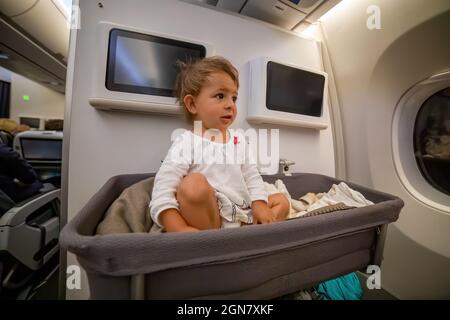 Baby girl wake up afret sleeping In Bassinet On Airplane. infant passenger on board Stock Photo Alamy