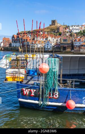 Detail at the hull of a fishing boat in Whitby harbour, Redcar and Cleveland district, North Yorkshire, England showing lobster pots ropes and fishing Stock Photo