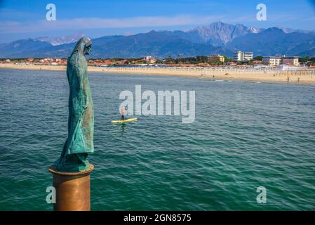 SUP Stand up paddle, bronze statue of St.Anthony, located in the sea near the pier, Marina di Pietrasanta, Versilia, Viareggio, Tuscany, Italy, Europe Stock Photo