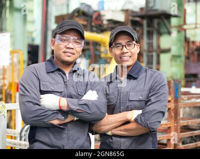 Two workers standing in factory Stock Photo