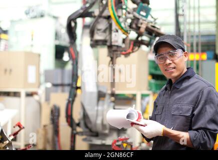 Workerman holding notepad in place work Stock Photo