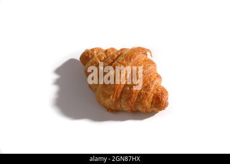 Croissant isolated in  wihite background with sunny light Stock Photo