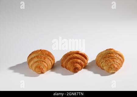 Croissant isolated in  wihite background with sunny light Stock Photo