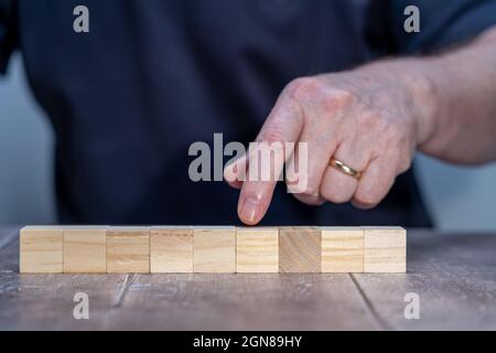 Nine timber block cube blank template mock up with a man in the background Stock Photo