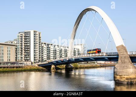 A bus passing over the Clyde Arc Bridge known locally as Squinty Bridge over the River Clyde in Glasgow, Scotland UK