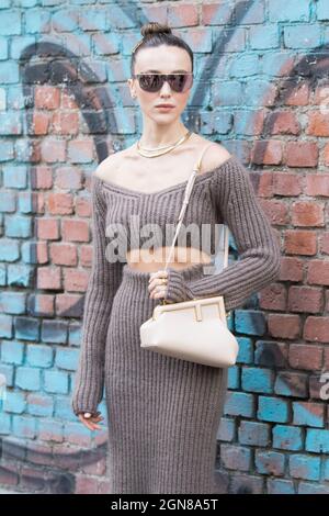 September 21, 2021: Model wears a low-cut brown ribbed dress Stock Photo