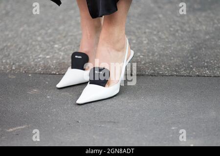 September 21, 2021: model wears a pair of white heeled shoes by Prada Stock Photo