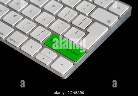 Computer keyboard shortcut keys in green to continue color indicating Book here now on a black backgound Stock Photo