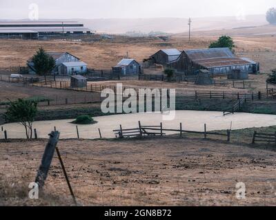 A country-western farm with horses and barn, quintessentially stunning. Stock Photo