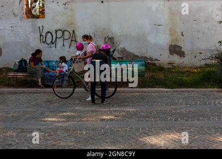 Milan, Italy - July, 05: Mother and sons get ready to ride a bike on July 05, 2021 Stock Photo