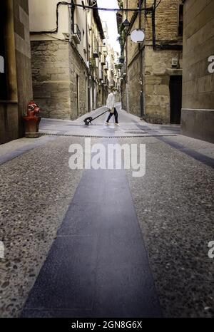 Detail of sick older woman walking through an old town Stock Photo