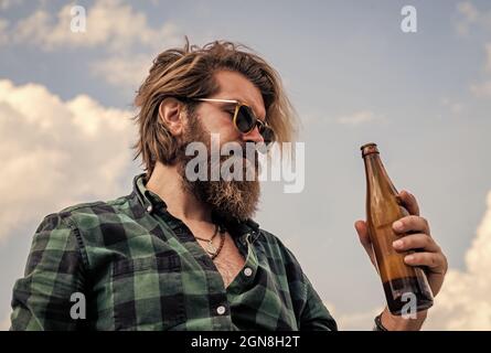 cheers. bearded man drink beer. handsome brutal man. time to relax. mature hipster with beard drinking beer. brutal caucasian hipster with glass water Stock Photo
