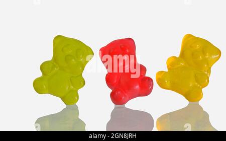 Dancing colorful jelly gummy bears, isolated on white background. Multicolored jelly bears candy isolated on a white background. Jelly Bean. Mirror Stock Photo
