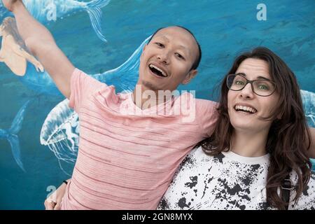 A smiling interracial couple: Caucasian woman and a Asian guy Stock Photo
