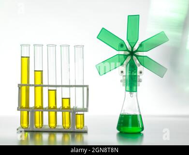 Oil in test tubes by beaker with green turbine on table Stock Photo