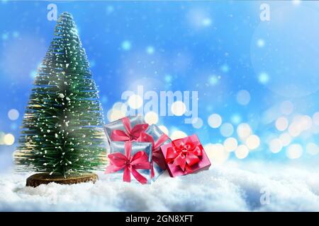 Christmas tree and magnificent gift boxes on snow. Christmas concept. Stock Photo