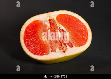 sliced yellow grapefruit on black background Stock Photo