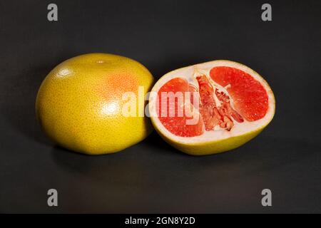 sliced yellow grapefruit on black background Stock Photo