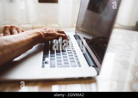 Senior woman using laptop at home Stock Photo
