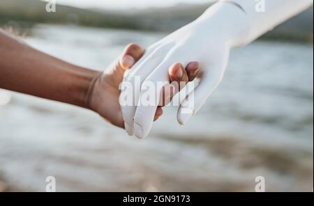 Young woman holding hand of robot Stock Photo