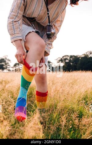 Woman wearing multi colored sock on meadow Stock Photo