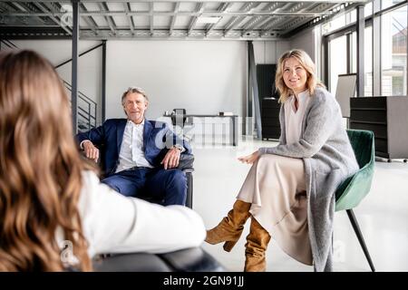 Male and female professionals discussing in office Stock Photo