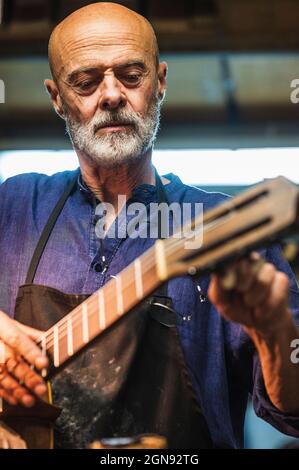 Smiling male craftsperson using digital tablet in workshop Stock Photo