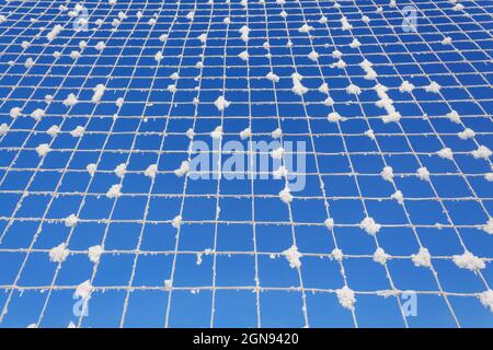 Volleyball net covered with snow. Nature's minimalism.  Stock Photo