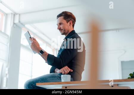 Thoughtful businessman having coffee at work place Stock Photo