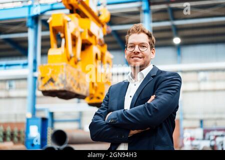 Male manager using digital tablet while standing by truck Stock Photo