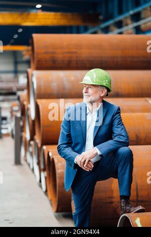 Male manager measuring metal with caliper in warehouse Stock Photo