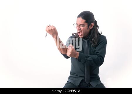 Person on white background. He is about to tear his shirt because he is angry and it looks like he is screaming. dressed in formal clothes. White spac Stock Photo