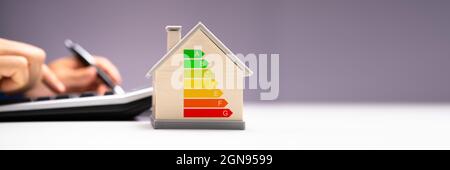 Calculating Energy Efficient House Consumption And Efficiency Stock Photo
