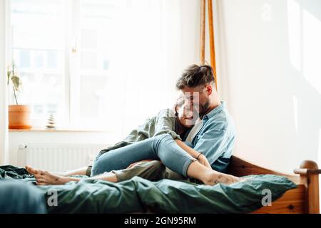 Male and female business colleagues discussing while working at home Stock Photo