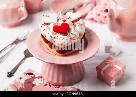 Pattern of heart shaped cookie cakes flat laid against pink background Stock Photo