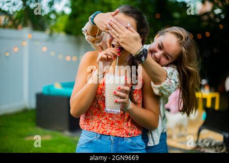 Peek a boo with friends in backyard Stock Photo