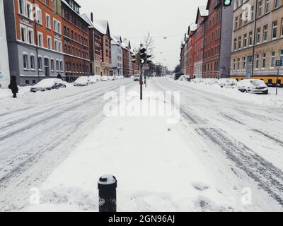 Winter landscape in the city of Braunschweig, Germany. Snow covered street and cars. Winter season with heavy snowfall Stock Photo