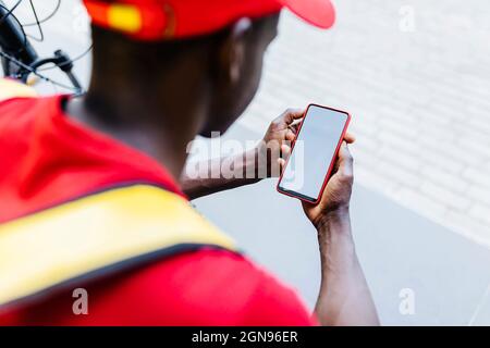 Delivery man using mobile phone Stock Photo