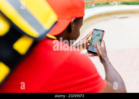 Young delivery man using map while working Stock Photo